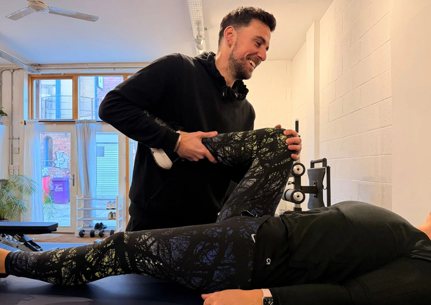 Physiotherapist performing a hip assessment