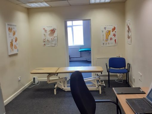 Treatment room with adjustable plinth and anatomy charts at the Bristol Southville clinic