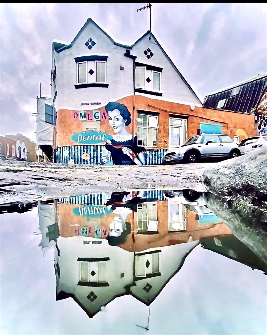 Omega Dental building exterior with mural, North Street, Bedminster (puddle reflection)