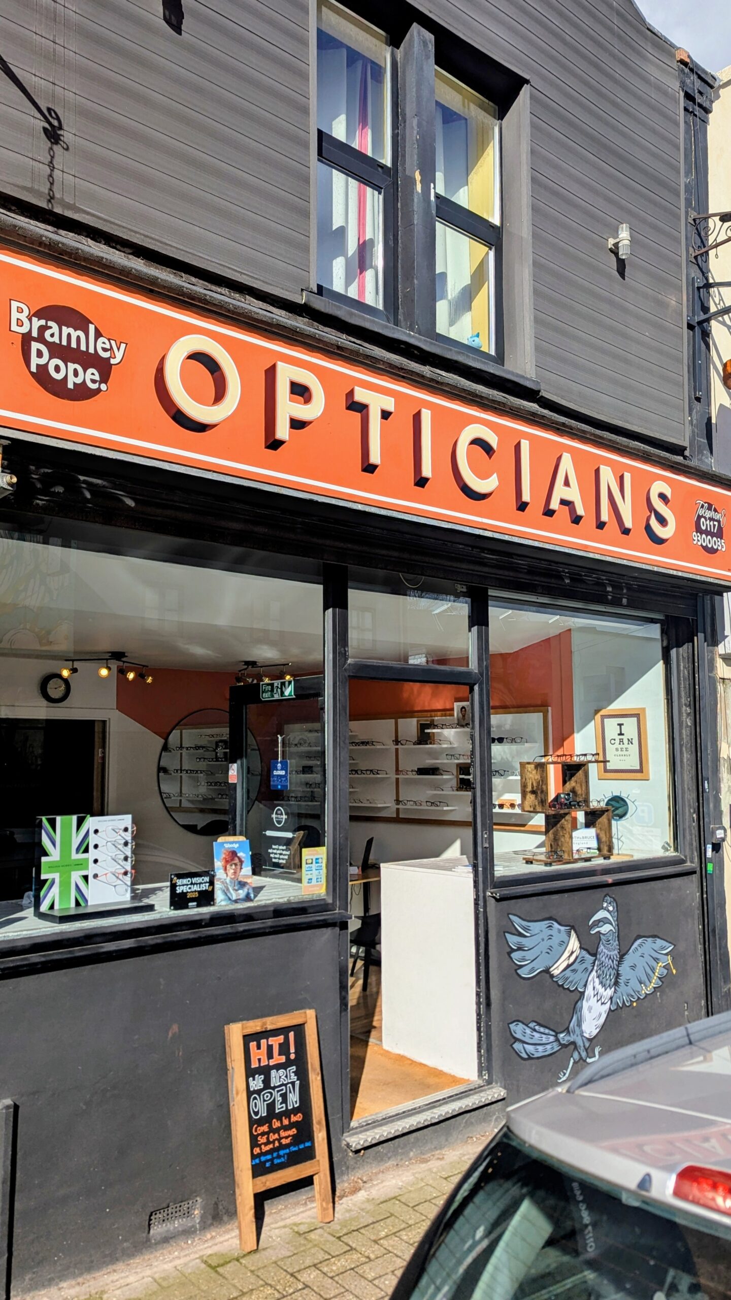 Bramley Pope Opticians orange shopfront at 52 North Street, Bedminster