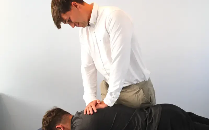 Practitioner with patient on a treatment bench