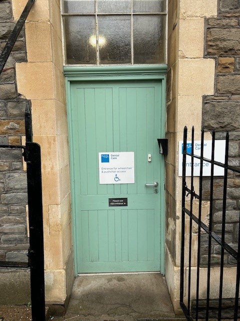 Side green door signed for wheelchair and pushchair access