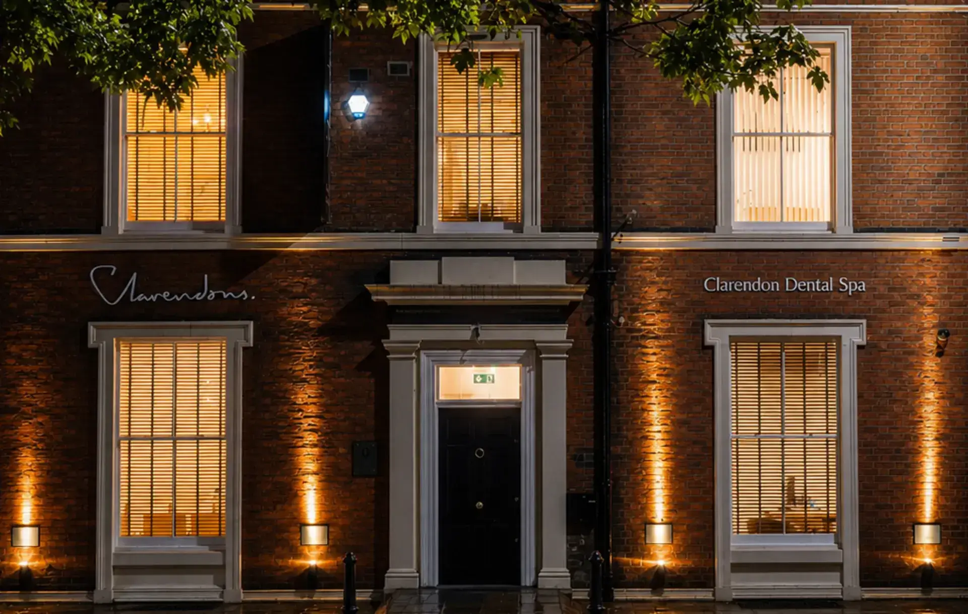 Clarendon Dental Spa exterior at night, Leeds city centre building with lit windows