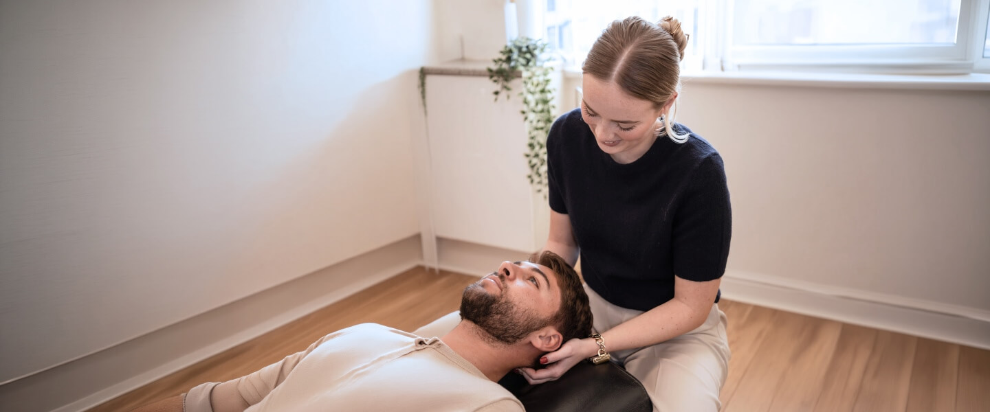 Chiropractor performing neck adjustment treatment