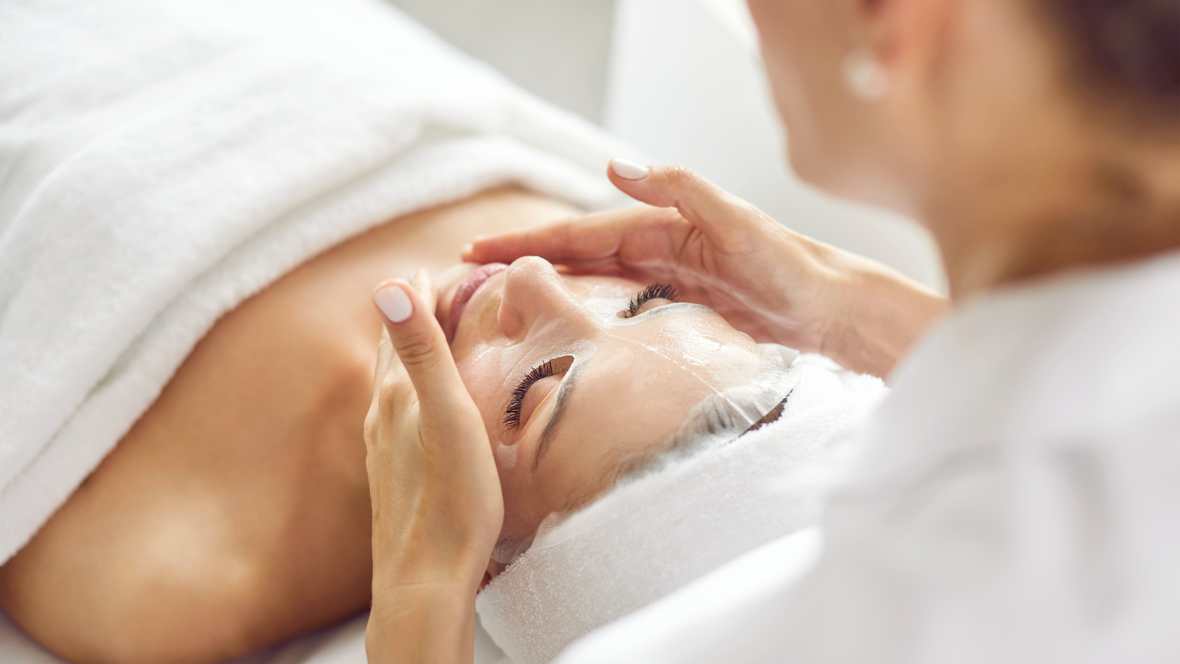 A relaxed woman received an Oxygenating O2 lift facial treatment