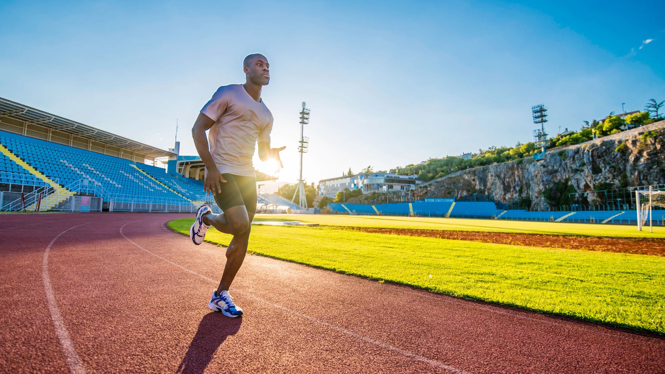 Athlete sprinting on an outdoor running track (site social/share image)