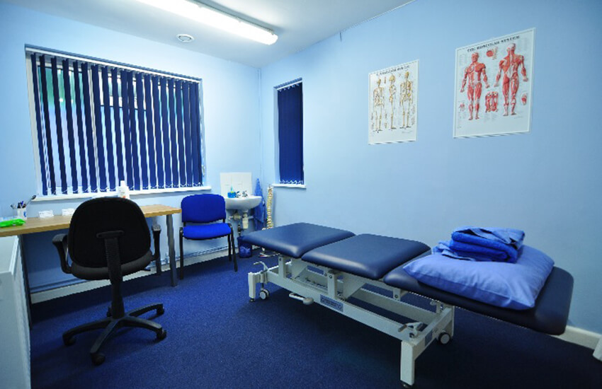 Physiotherapist in treatment room