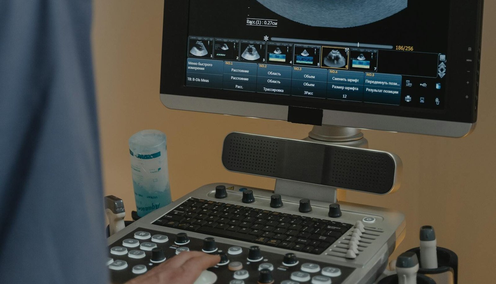 Healthcare professional using ultrasound machine for diagnostic imaging and guided injections