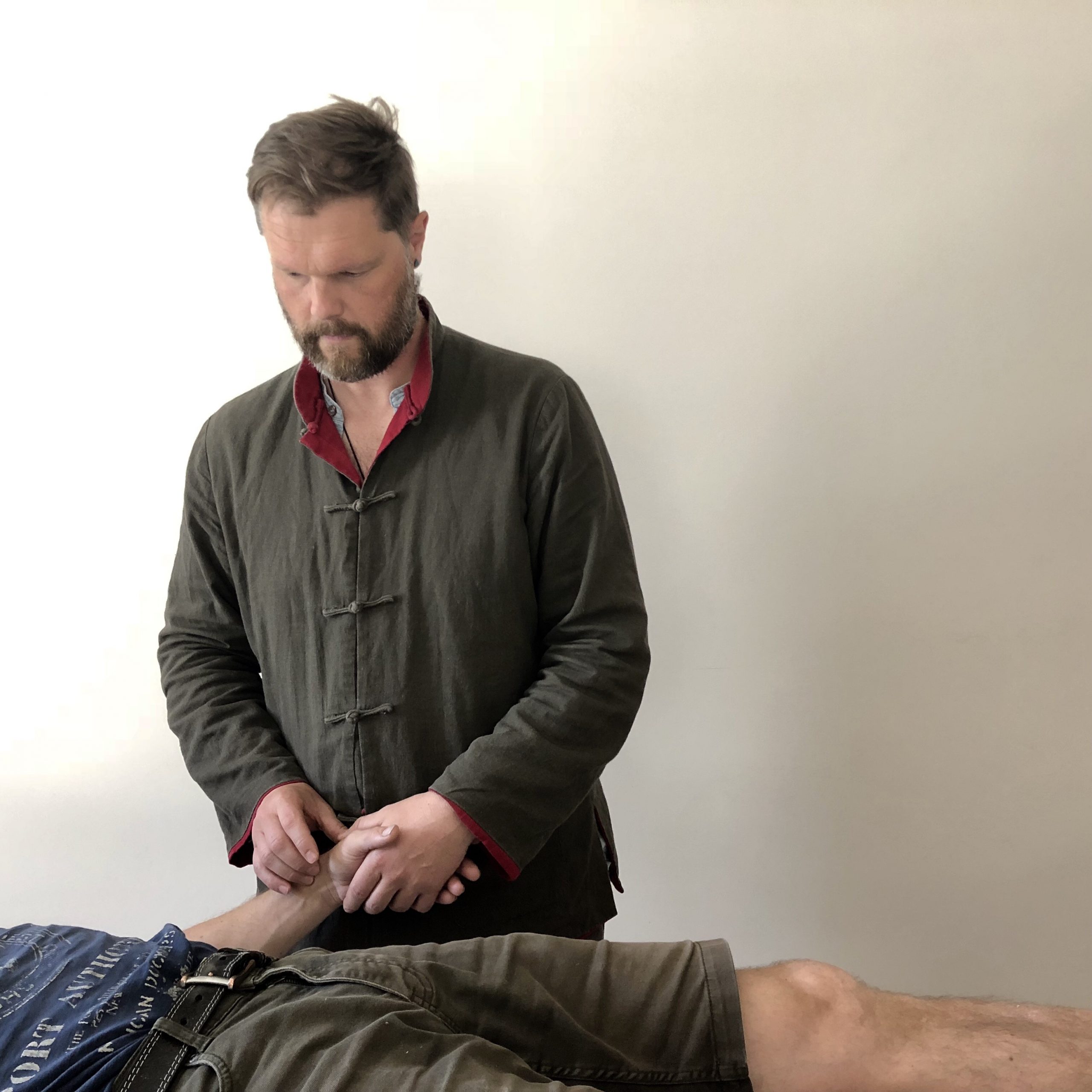Roland Lewis performing acupuncture treatment