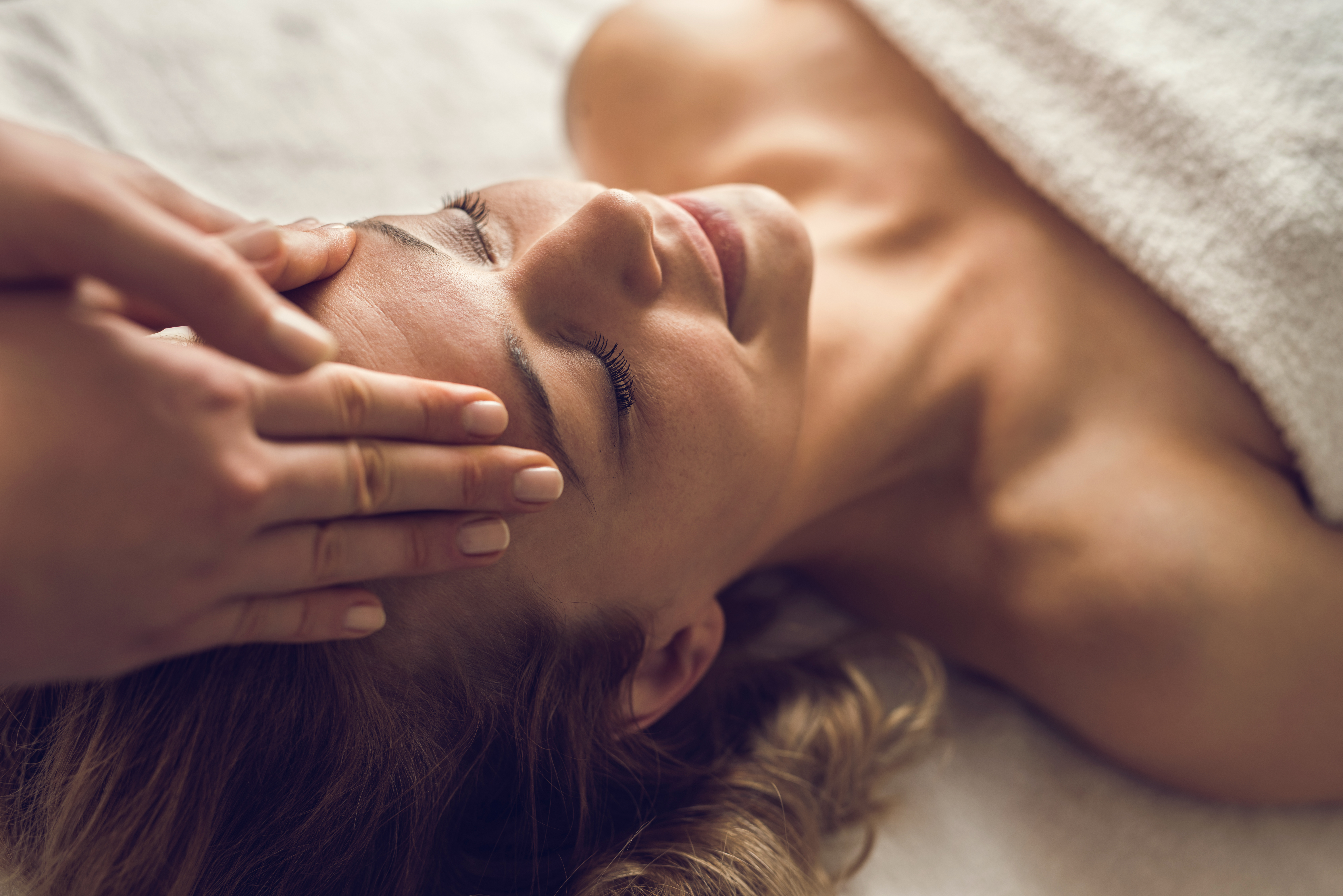 A person receiving a head massage