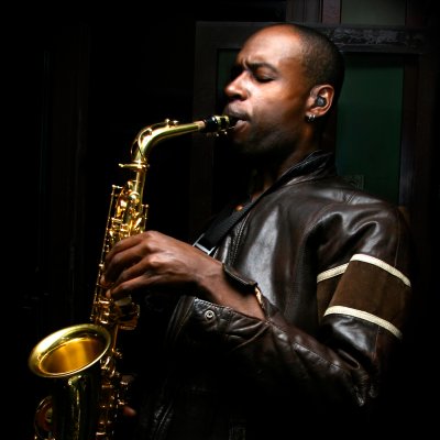 Man playing saxophone with hearing protection