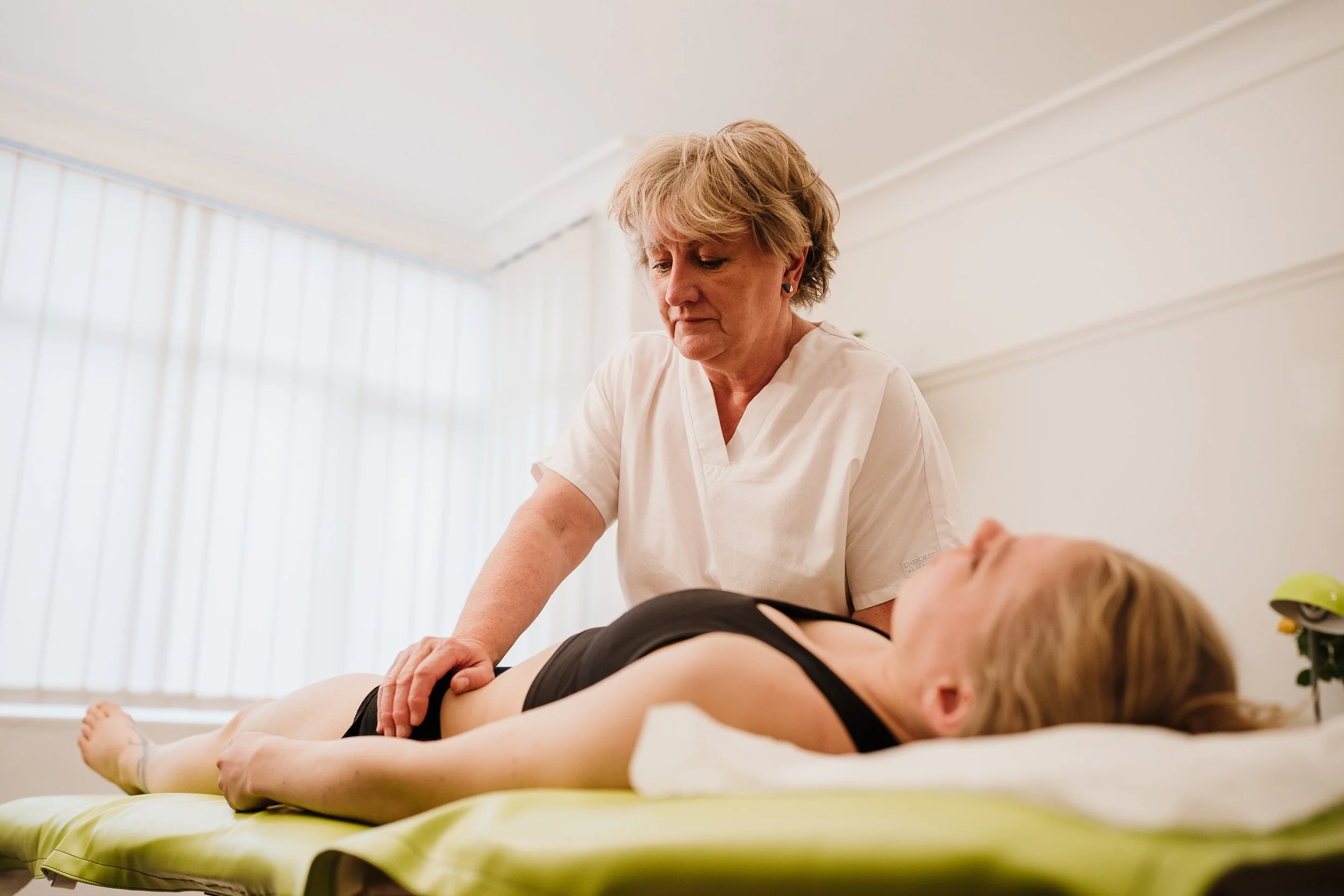 Osteopath treating patient with chronic pain